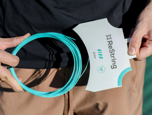 tennisnerd reviews restring vivo - person opening vivo recycled polyester tennis string from biodegradable packaging