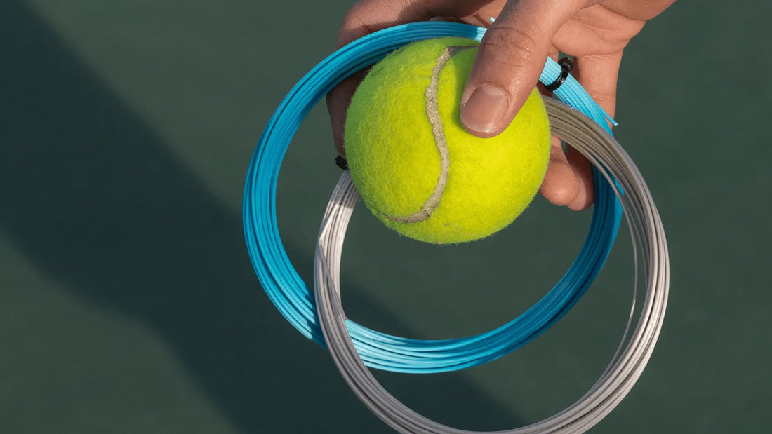 person holding two polyester tennis strings and a tennis ball