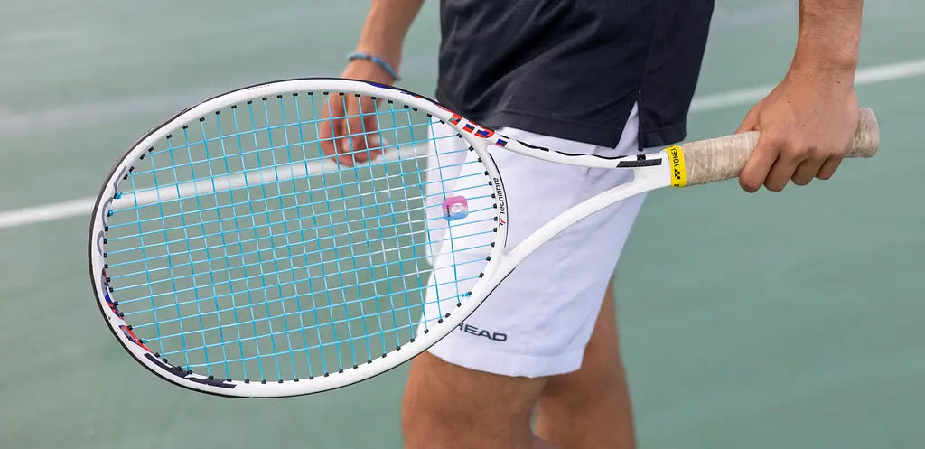 man holding tennis racket with ReString zero strings