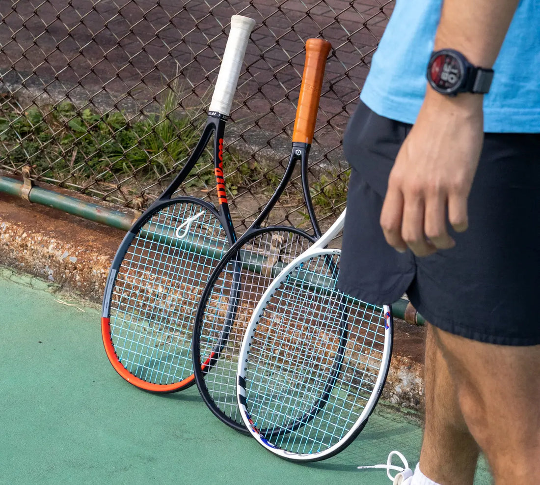 three tennis rackets against a court railing why pros use many rackets